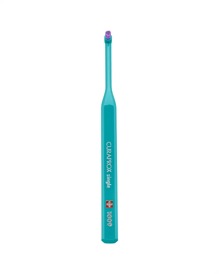 Curaprox CS 1006 single-tuft toothbrush, small tuft of filaments on a compact head for precise cleaning around brackets and along the orthodontic wire.